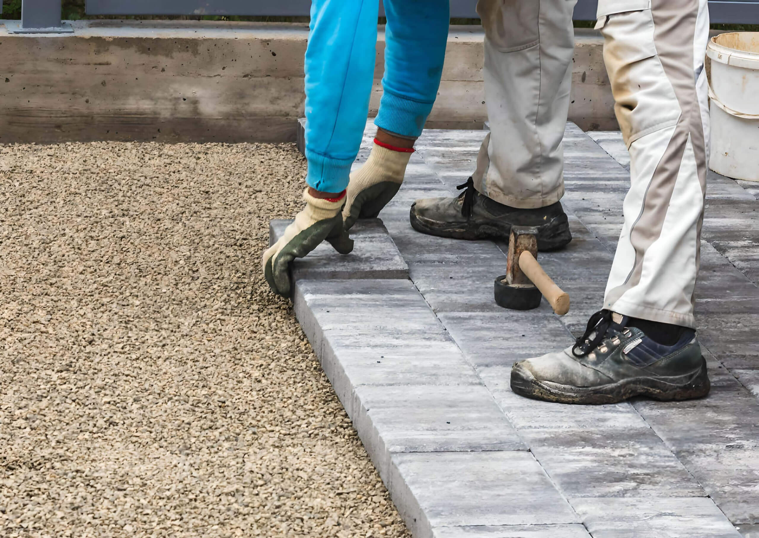 Workers installing concrete bricks